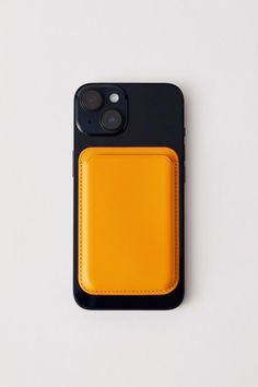 an iphone case with a card holder attached to the back of it, sitting on a white surface