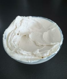 a bowl filled with whipped cream on top of a table