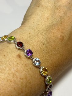 This genuine bright red garnet, citrine, blue topaz, amethysts, and peridot bracelet is very lively and bright. The stones are deep colors natural stones The sterling silver is plated with rhodium to protect the bracelet from tarnish 7.5 in Our jeweler can shorten it for $20 All jewelry is shipped free in the US in a nice gift box. Check out our over a THOUSAND great reviews Engraving is $4 per letter and is not always perfect depending on the piece. It can take a few days if the jeweler is busy Elegant Multicolor Sterling Silver Bracelet With Stones, Elegant Multicolor Sterling Silver Bracelet, Multicolor Round Sterling Silver Bracelet, Multicolor Sterling Silver Bracelets With Gemstone Accents, Sterling Silver Multicolor Gemstone Bracelets, Multicolor Gemstone Sterling Silver Bracelet, Elegant Multicolor Stones Sterling Silver Bracelet, Multicolor Gemstone Crystal Bracelet, Elegant Multicolor Gemstone Sterling Silver Bracelet