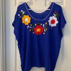 Gorgeous And Vibrant Blouse With Beautiful Stitching And Flower Detail. Nwot Blue Floral Embroidery Top For Vacation, Blue Floral Embroidery Beach Tops, Blue Floral Embroidery Blouse For Summer, Blue Floral Embroidered Summer Blouse, Blue Embroidered Top For Vacation, Bohemian Short Sleeve Blue Blouse, Bohemian Blue Short Sleeve Blouse, Embroidered Blue Blouse For Vacation, Flower Detail