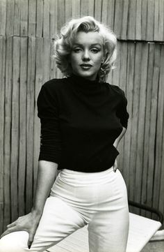 a black and white photo of a woman posing