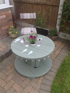 an outdoor table with flowers on it