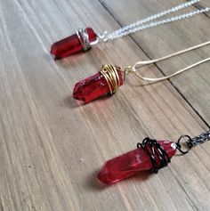 Beautifully elegant raw red quartz crystal pendant wire wrapped by hand and placed on a chain of your choice.  Length and shape of stones vary from 1-1.5 inches, as every stone is unique and magnificently perfect, and is wrapped by hand, so every pendant will look different.  Choose a necklace with chain and wire made from 18k gold plated stainless steel, dark sliver, or 925 sterling silver. All wire and chain is plated stainless steel, and length of chain is 18 inches. Please note that each necklace type is sold separately.  Be sure to check out more HANDMADE jewelry in my shop, DizzleBees, beautiful jewelry of all kinds available! Made with quality materials and always nickel and lead free metals ♡ Perfect gift for a friend or loved one: All jewelry pieces are packaged in silver silk jew Red Gemstone Pendant Crystal Necklaces, Red Pendant Crystal Necklaces With Gemstone, Red Crystal Pendant Necklaces, Red Gemstone Pendant Crystal Necklace, Red Hand Wrapped Necklace As Gift, Hand Wrapped Red Necklace As Gift, Red Hand Wrapped Necklace For Gift, Red Wire Wrapped Pendant Necklace, Goth Necklace