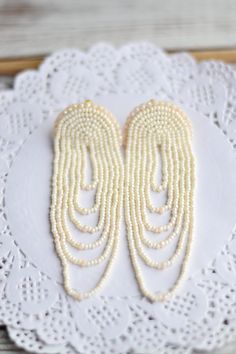 "Wedding bridal earrings Gold ivory bohemian fringe earrings Statement boho chandelier tassel dangle seed beaded Size: length - 10cm (4 inches) width - 3.5 cm (1.5 inches) ❤ CUSTOM ORDERS It is ABSOLUTELY HANDMADE . So if you like this item in a different color or size, send me a message please. I will send you a link for a \"custom order\" and you'll be able to place the order there. Please feel free to communicate with me. SHIPPING Item will be shipped carefully packed in a GIFT BAG!! Shipping Bohemian Beaded Drop Bridal Earrings, Bohemian Beaded Bridal Drop Earrings, White Pearl Beaded Bohemian Earrings, Bohemian Tassel Dangle Earrings For Wedding, Bohemian White Pearl Beaded Earrings, Bohemian Beaded Bridal Earrings, Bohemian Bridal Pearl Drop Earrings, White Fringe Dangle Chandelier Earrings, Bohemian Beaded Dangle Earrings For Wedding