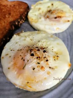 two fried eggs are on a plate with toast