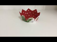 a red and white paper bowl with snowflakes on it