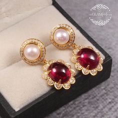 This earring pair is made with cultured pearl round cabochon, synthetic ruby oval cabochon and best quality signity brand cubic zirconia diamond cut rounds. Sizes: Pearl cabochon is 8 mm round Ruby cabochon is 12 mm x 10 mm Synthetic ruby cabochon is of rich red pink color which looks exactly like real ruby cabochon and cultured pearl we used is of slight pink rosey color so they both compliments each other very well. Metal we used is guaranteed silver 925 which is real gold filled, Gold Filling Exquisite Round Cabochon Earrings, Luxury Round Gemstone Pearl Earrings, Luxury Pearl Earrings With Gemstone, Elegant Cabochon Pearl Drop Earrings, Diamond Cabochon Earrings For Anniversary, Elegant Oval Cabochon Earrings For Anniversary, Anniversary Diamond Cabochon Earrings, Silver Round Elegant Cabochons, Elegant Silver Round Cabochons