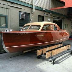 a wooden boat being worked on in a garage