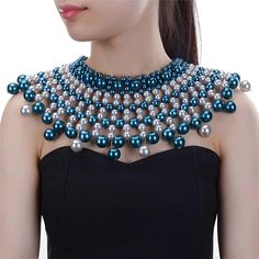 a woman wearing a blue and silver beaded necklace with pearls on the neck,