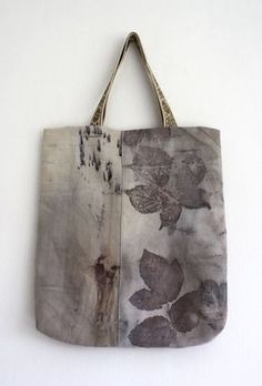 a bag hanging on the wall with leaves painted on it