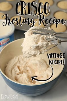 a bowl filled with whipped cream next to muffins and cupcake tins