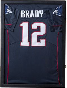 a football jersey in a wooden frame with the name brady 12 on it's chest