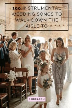 the bride and her flower girl walk down the aisle to their wedding ceremony in an old building