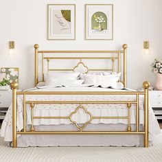 a white and gold bedroom with pictures on the wall above the bed, along with two nightstands