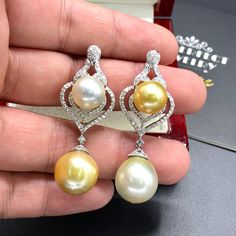 We are presenting you a HUGE pair of CHANDELIER, Genuine, Golden & White South Sea Pearls, extremely FINE A+, LUSTROUS and Rare! Accenting the 4 pearls are 110 pieces of F/VS Natural diamonds, weighting a total of 1.30 carats. Set in fabulously designed 18K solid white gold, chandelier earrings ONLY ONE ITEM AVAILABLE!! NO DUPLICATES!! WHAT YOU SEE IN THE PICTURES IS WHAT YOU WILL GET SOLIDLY HANDCRAFTED EARRINGS! SUGGESTED RETAIL VALUE: $8,500 PEARLS: Size: Bottom 14 x 15 mm, top 12 mm roun Luxury Yellow Gold Drop Pearl Earrings, Luxury Yellow Teardrop Earrings, Luxury Yellow Dangle Earrings, Luxury White Drop Earrings, Elegant Pear-shaped Yellow Earrings, Elegant Yellow Pear-shaped Earrings, Gold Chandelier Earrings, Vvs Diamond, Golden South Sea Pearls