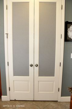 two white double doors in the corner of a room