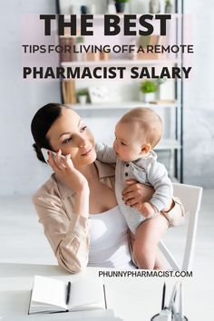 a woman holding a baby in her arms while sitting at a table with an open book