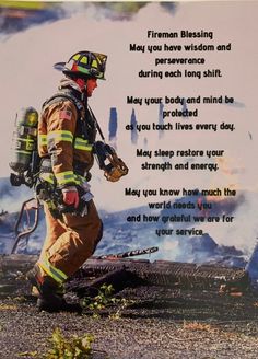 a firefighter standing on top of a pile of rubble next to a burning building