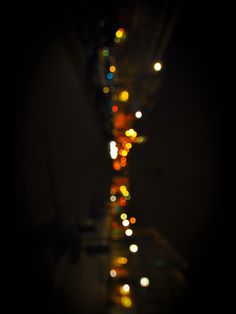 blurry photograph of street lights in the dark