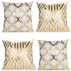 four gold and white pillows with geometric designs