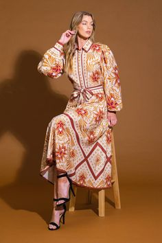 A printed woven midi dress featuring shirt collar, button down, long sleeve with cuff, self sash tie and full skirt Details: Self : 100% Polyester Size & Fit - Model is 5`8" And Wearing Size Small- Measurements Taken From Size Small- Approx. Length: 50" Spring Beige Dress With Belted Cuffs, Beige Spring Dress With Belted Cuffs, Spring Beige Dresses With Belted Cuffs, Beige Long Sleeve Dress With Belted Cuffs, Beige Spring Dresses With Belted Cuffs, Beige Dress With Belted Cuffs For Spring, Fall Floral Print Button-up Maxi Dress, Fall Beige Dress With Belted Cuffs, Beige Fall Dress With Belted Cuffs