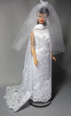 a doll wearing a wedding dress and veil