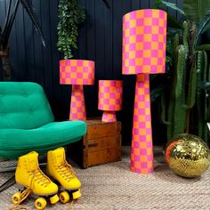 two yellow roller skates sitting next to a green chair