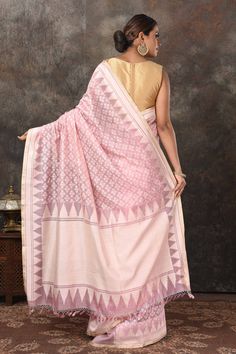 Radiate elegance on special occasions in this powder pink Jamdani weave Banarasi sari. It comes with a beautiful blouse piece. Disclaimer: The shown stitched blouse on the model is for display purpose only. The saree comes with a matching blouse piece and finished with fall and piko. Semi-stitched Pink Handloom Saree, Pink Jamdani Saree Look, Pink Saree With Woven Motifs, Transitional Pink Banarasi Silk Pre-draped Saree, Purple Jamdani Saree, Fashion Journals, Traditional Fabric, Georgette Sarees, Banarasi Sarees