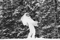 black and white photograph of a bride in the snow