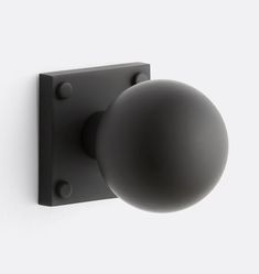 a black ball mounted to the side of a wall