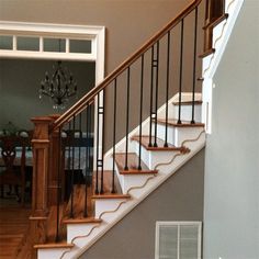 a stair case in a house next to a table and chairs