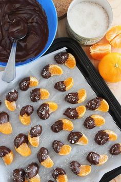 there are oranges and chocolate on the baking sheet