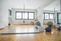 an empty room with exercise balls and yoga mats