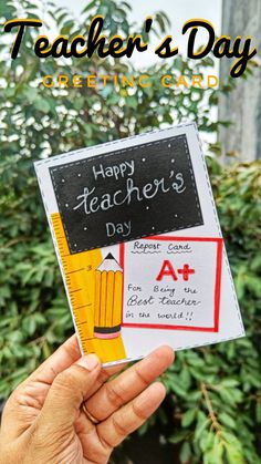 someone holding up a teacher's day greeting card