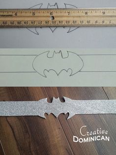 a ruler and some cut outs on top of a wooden floor with the word bat