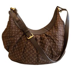 An authentic Louis Vuitton Rhapsody MM. The bag features an Idylle Monogram canvas, brown leather trim, and gold-toned hardware. The interior is lined with brown fabric and there are two slip pockets inside. The interior is neat & clean. The exterior, trim, and hardware have very minor signs of use overall the bag is in good pre-loved condition. Mm Monogram, Exterior Trim, Brown Fabric, Monogram Canvas, Authentic Louis Vuitton, Fashion Handbags, Leather Trims, Inside Pocket, Brown Leather