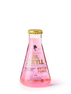 a pink liquid bottle filled with water and gold cap