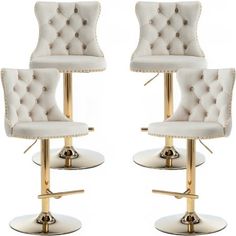 a pair of white chairs with gold trimmings and buttons on the back, sitting next to each other