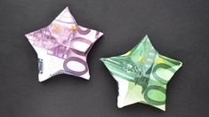 two folded money stars sitting next to each other