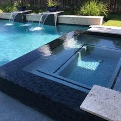 an outdoor pool with water features and landscaping