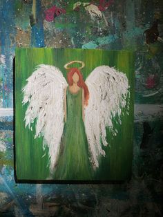 an angel painting on a green background with white wings