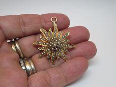 Wonderful Antique 14K Gold fine jewelry~ Pendant Charm & brooch~ Lavalier Bright Gold with several set pearls ~ Sunburst~ Starburst shape  Jewelry that can be worn as a brooch or as a pendant There is a articulating bale in the back to switch back and forth between a brooch and pendant. Victorian~ Edwardian pin brooch  Circa 1920  Comes with a nice velvet case Stamp 14k  Nice high quality solid gold  color Piece of collection ! In good condition~ See photos  Size: 1 1\2 inch x 1 1\4 inch  Size: Gold Flower Pendant Brooch Jewelry, Antique Yellow Gold Star Jewelry, Antique Gold Star-shaped Jewelry, Bright Gold, Jewelry Pendant, Gold Charm, Lapel Pin, Pin Brooch, Favorite Things Gift