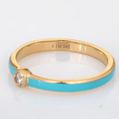 Stylish turquoise & diamond stacking band crafted in 14 karat yellow gold.   1 round brilliant cut diamonds total an estimated 0.03 carats (estimated at H-I colour and SI2 clarity).   The enamelled band is a striking turquoise colour with a small diamond to the centre of the band. The low rise ring (2mm - 0.07 inches) sits comfortably on the finger. Great worn alone or stacked with your fine jewellery from any era.   The ring is in very good condition.   Particulars:  Weight: 1.3 grammes  Stones Gold Diamond Turquoise Ring, Turquoise Enamel Anniversary Ring, Turquoise Enamel Ring For Anniversary, Fine Gold Turquoise Ring With Diamond Accents, Gold Diamond Turquoise Ring For Anniversary, Gold Turquoise Diamond Ring, Diamond Stacking Band, Stacked Diamond Bands, Stacking Bands