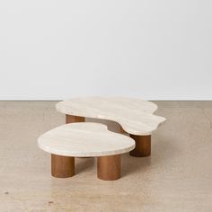 two tables sitting on top of each other in the middle of a floored room