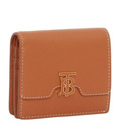 Burberry presents this TB Monogram bifold wallet in grained leather for a textured feel. The supreme utility of this style is matched only by the polished details, such as the application of hand-painted edges and gold-tone finishings on the signature hardware. Classic Bifold Wallet With Engraved Logo, Designer Tan Bifold Wallet, Formal Bifold Wallet With Embossed Logo, Gold Bifold Wallet For Business, Leather Bifold Wallet With Embossed Logo, Tan Bifold Wallet With Card Slots, Luxury Bifold Wallet With Embossed Logo, Luxury Wallets With Grained Texture For Formal Occasions, Formal Leather Wallet With Grained Texture