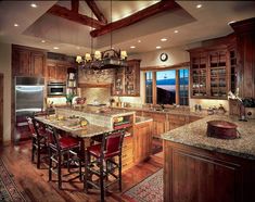 a large kitchen with wooden cabinets and granite counter tops, along with a center island