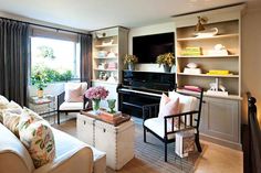 a living room filled with furniture and a piano