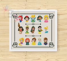 the princesses cross stitch pattern is displayed on a wooden surface, with an arrow pointing to