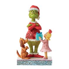 a statue of the grinch and his family is shown in this christmas scene with santa's helper