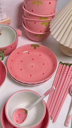 pink dishes and utensils on a white table